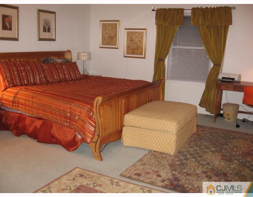 399 Plainfield Road Edison, NJ 08820 - Photo 3 of 8 a bedroom with a bed and a couch