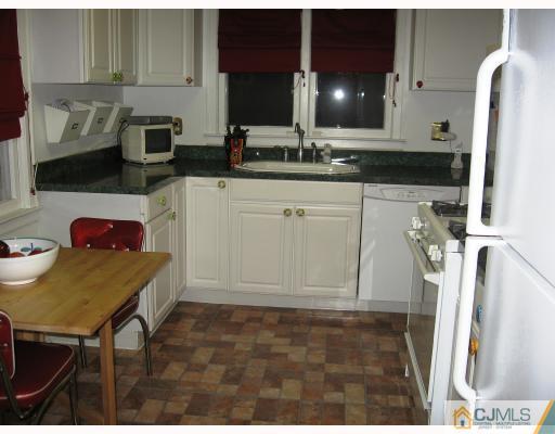 399 Plainfield Road Edison, NJ 08820 - Photo 4 of 8 a kitchen with a sink and cabinets