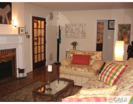 399 Plainfield Road Edison, NJ 08820 - Photo 6 of 8 a living room with furniture and a fireplace
