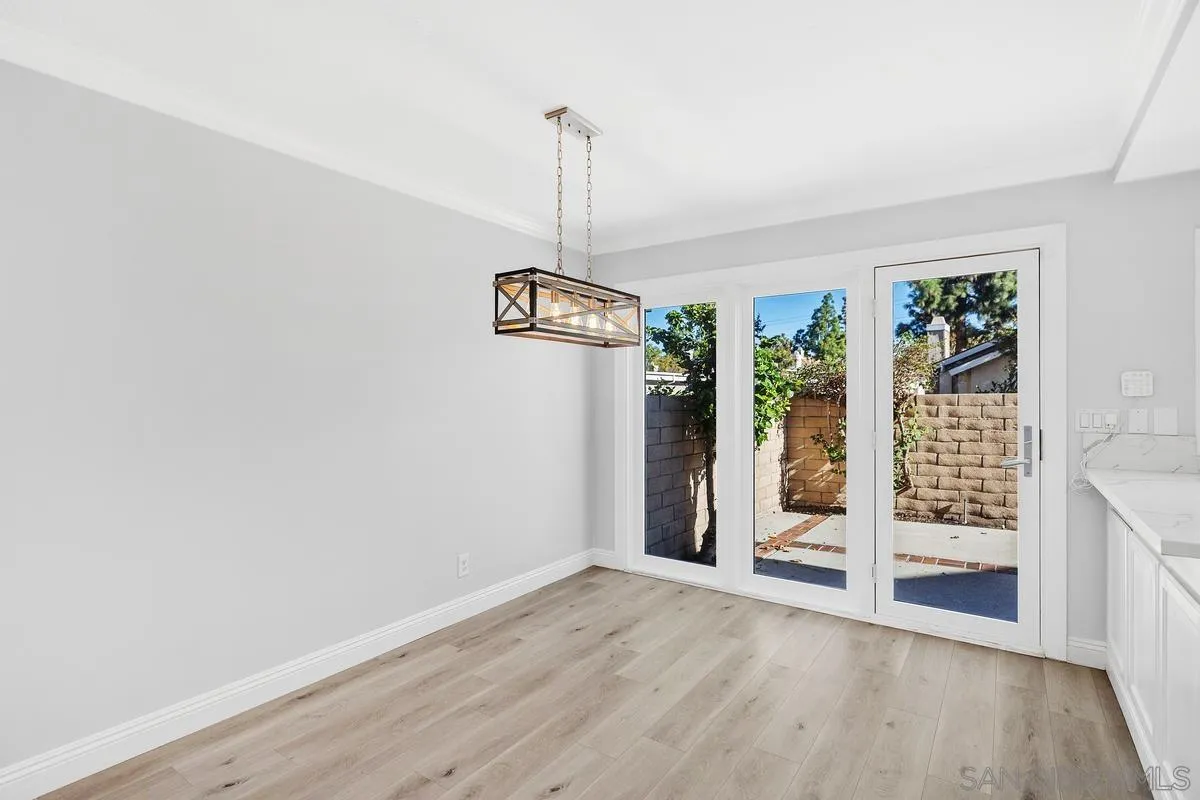 14 Dragonfly, Unit 25 Irvine, CA 92604 - Photo 11 of 32 an empty room with wooden floor and windows