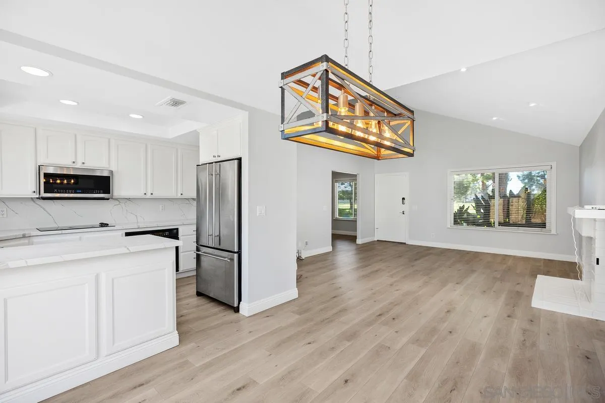 14 Dragonfly, Unit 25 Irvine, CA 92604 - Photo 13 of 32 a kitchen with stainless steel appliances granite countertop a refrigerator and a stove top oven