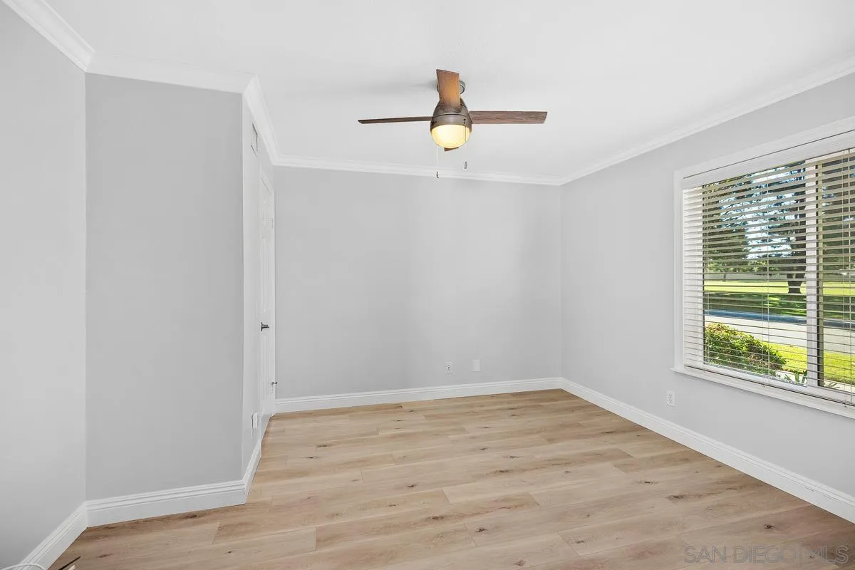 14 Dragonfly, Unit 25 Irvine, CA 92604 - Photo 18 of 32 a view of an empty room with wooden floor and a window