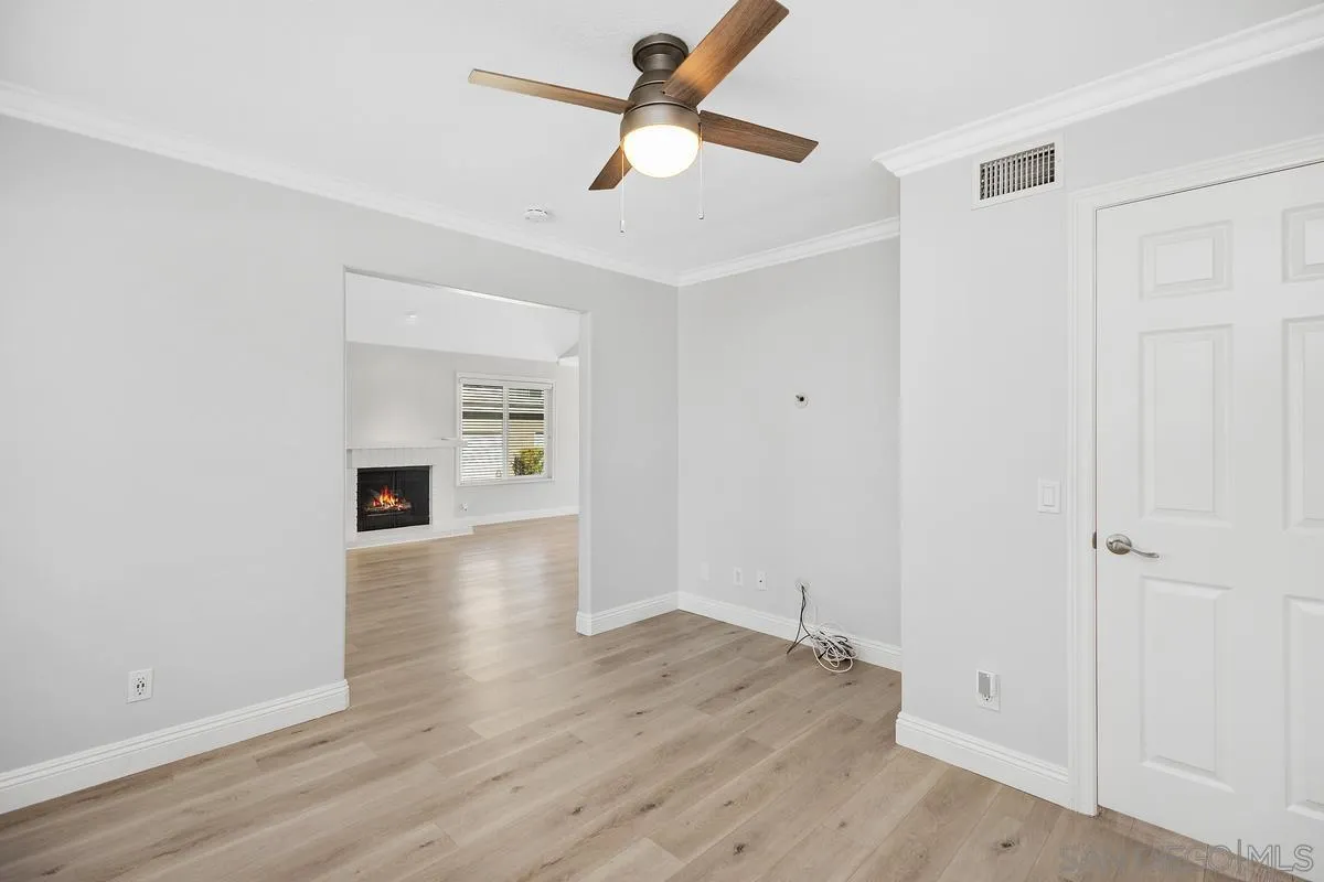 14 Dragonfly, Unit 25 Irvine, CA 92604 - Photo 19 of 32 an empty room with wooden floor ceiling fan and windows