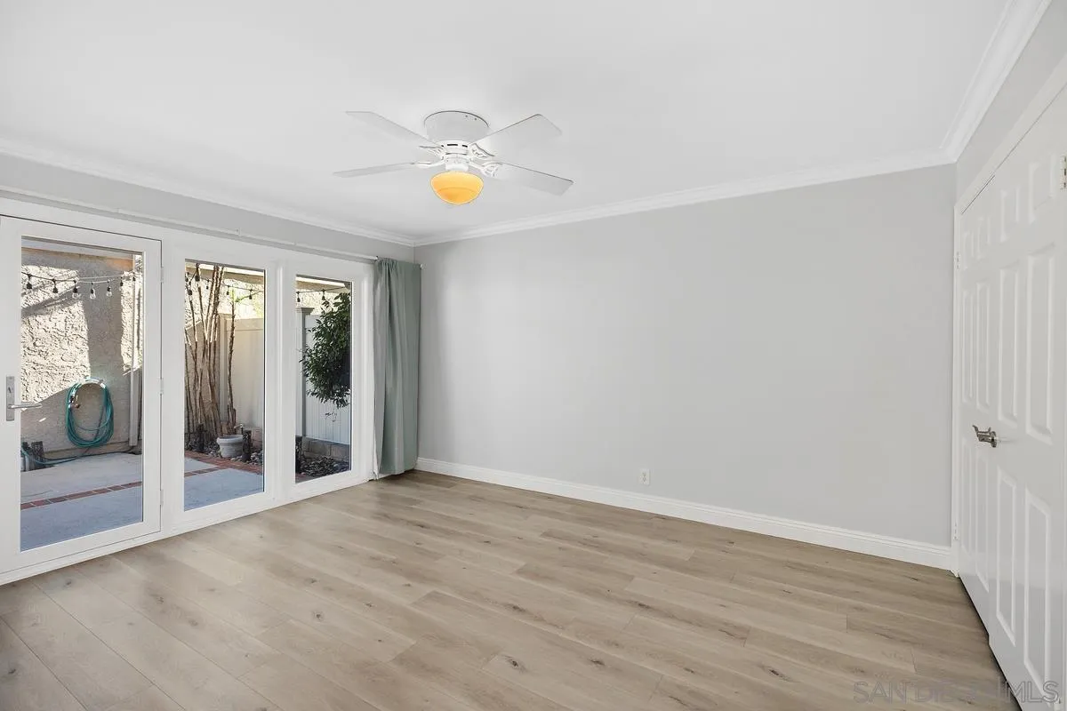 14 Dragonfly, Unit 25 Irvine, CA 92604 - Photo 23 of 32 a view of an empty room with wooden floor and a window