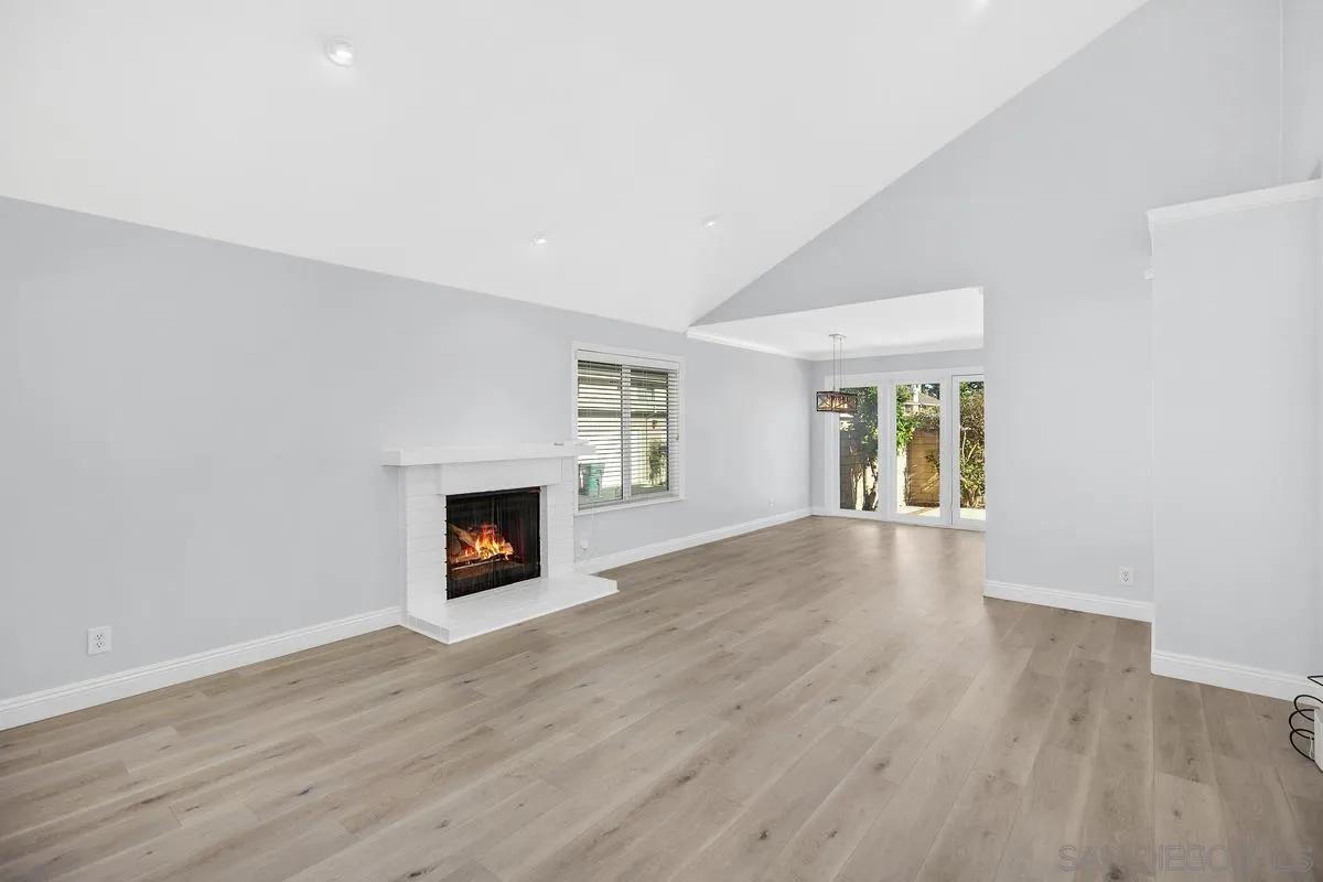 14 Dragonfly, Unit 25 Irvine, CA 92604 - Photo 5 of 29 a view of a livingroom with wooden floor and a fireplace