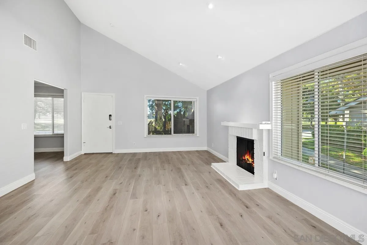 14 Dragonfly, Unit 25 Irvine, CA 92604 - Photo 6 of 29 a view of empty room with wooden floor and fireplace