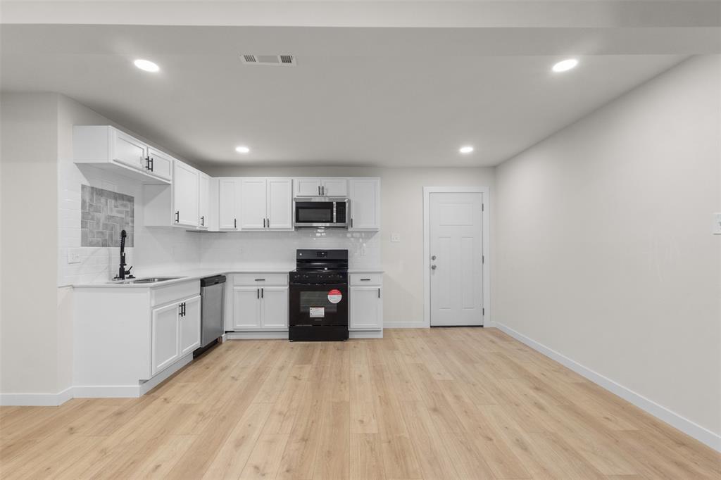 3811 Malden Lane Dallas, TX 75216 - Photo 14 of 33 a large kitchen with stainless steel appliances granite countertop a refrigerator and a stove top oven