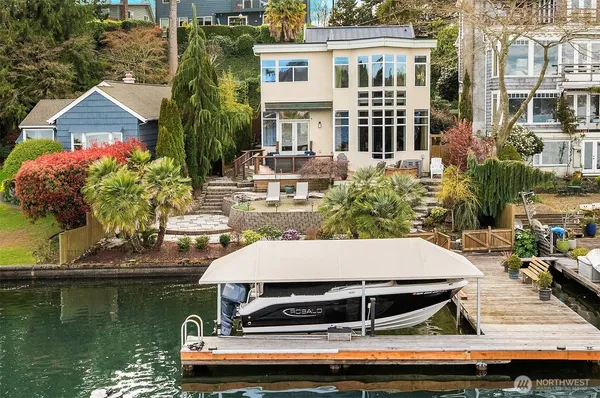 a view of a house with pool and chairs