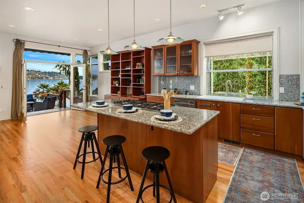a kitchen with a table chairs and wooden floor