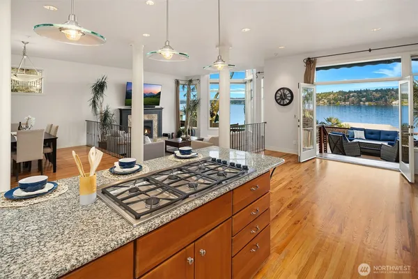 a large kitchen with stainless steel appliances granite countertop a sink stove and refrigerator