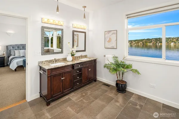 a spacious bathroom with a granite countertop sink and a mirror