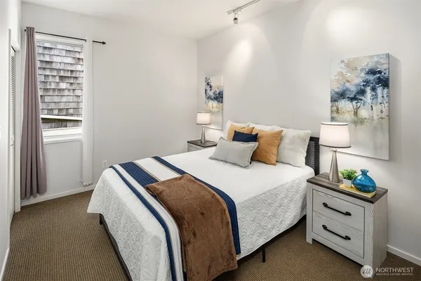 a bedroom with a bed and a window