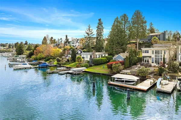 a view of water with boats and trees in the background