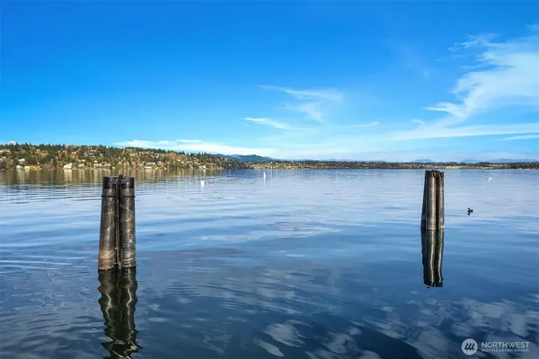 a view of a lake with a floor to ceiling window