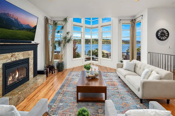 a living room with furniture a flat screen tv and a fireplace