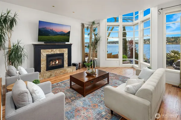 a living room with furniture a flat screen tv and a fireplace