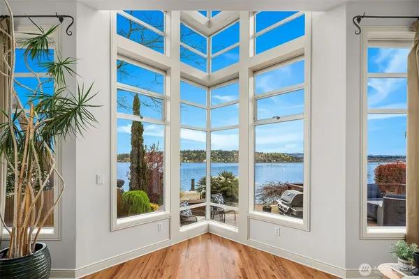 a view of a bedroom with a window and wooden floor