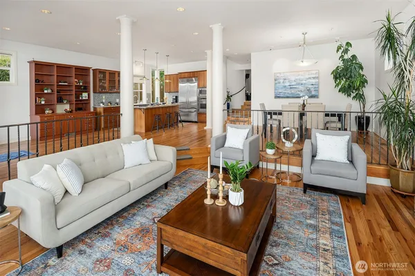 a living room with furniture wooden floor and a table