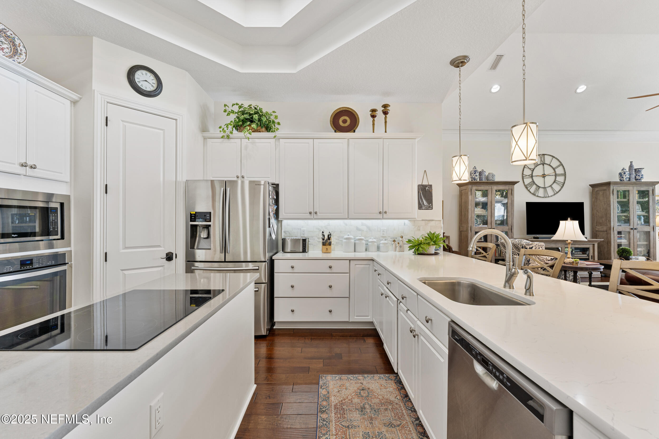 686 Frederic Drive Fleming Island, FL 32003 - Photo 12 of 57 a kitchen with white cabinets and stainless steel appliances