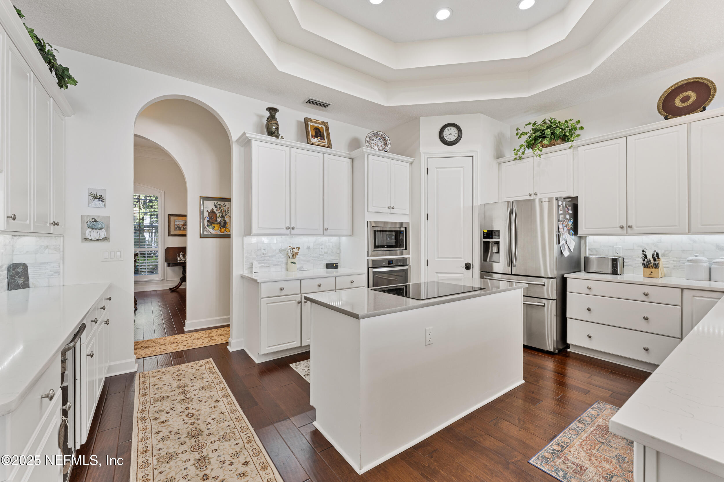 686 Frederic Drive Fleming Island, FL 32003 - Photo 13 of 57 a kitchen with white cabinets and stainless steel appliances