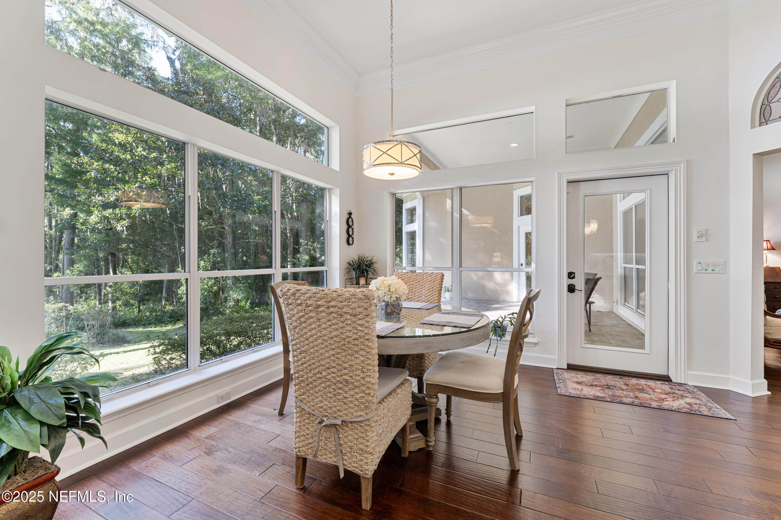 686 Frederic Drive Fleming Island, FL 32003 - Photo 16 of 57 a dining room with furniture wooden floor and a chandelier