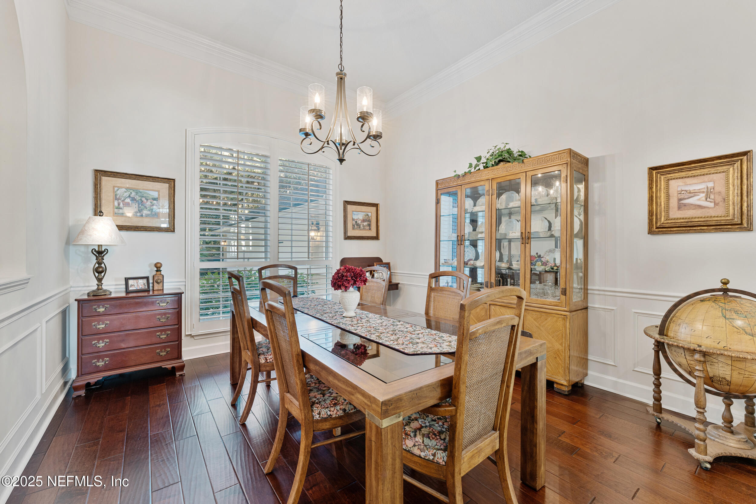 686 Frederic Drive Fleming Island, FL 32003 - Photo 20 of 57 a dining room with furniture a chandelier and wooden floor