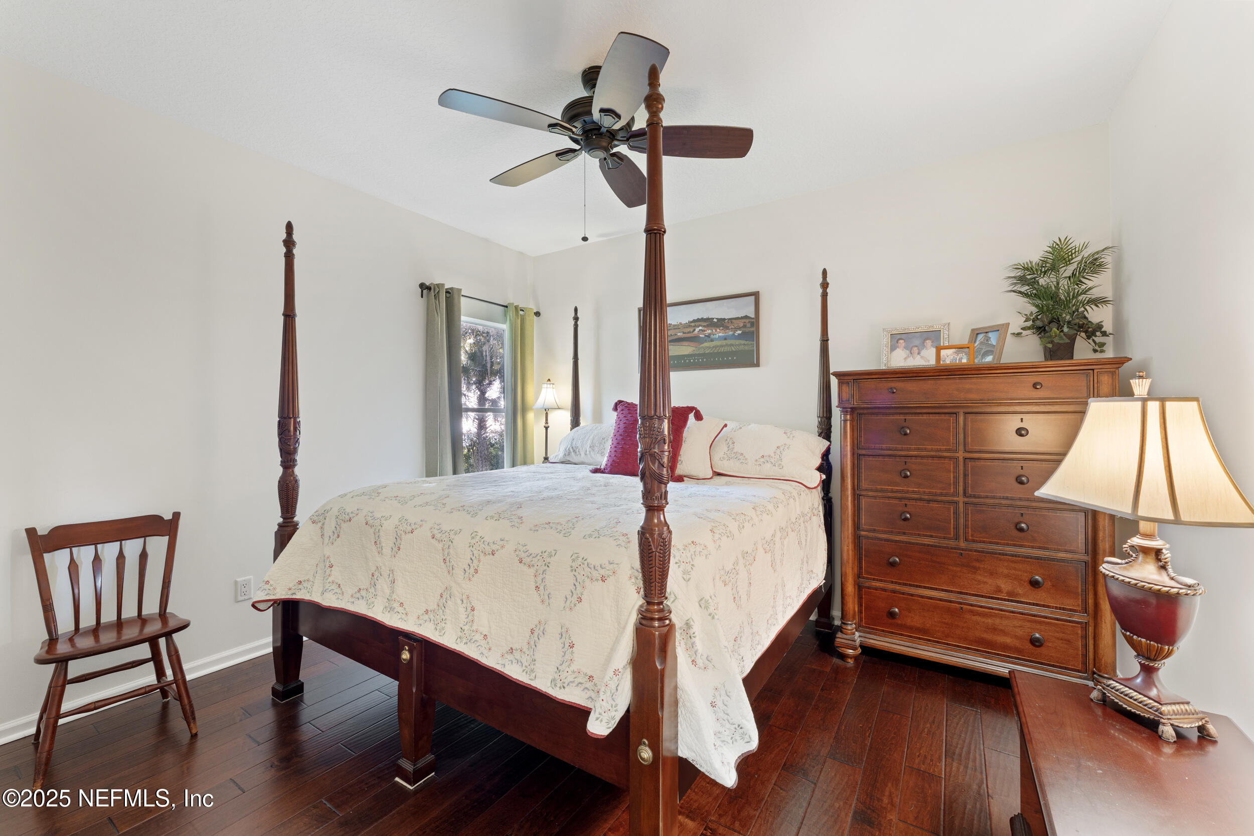 686 Frederic Drive Fleming Island, FL 32003 - Photo 28 of 57 a bed room with a bed and a chandelier