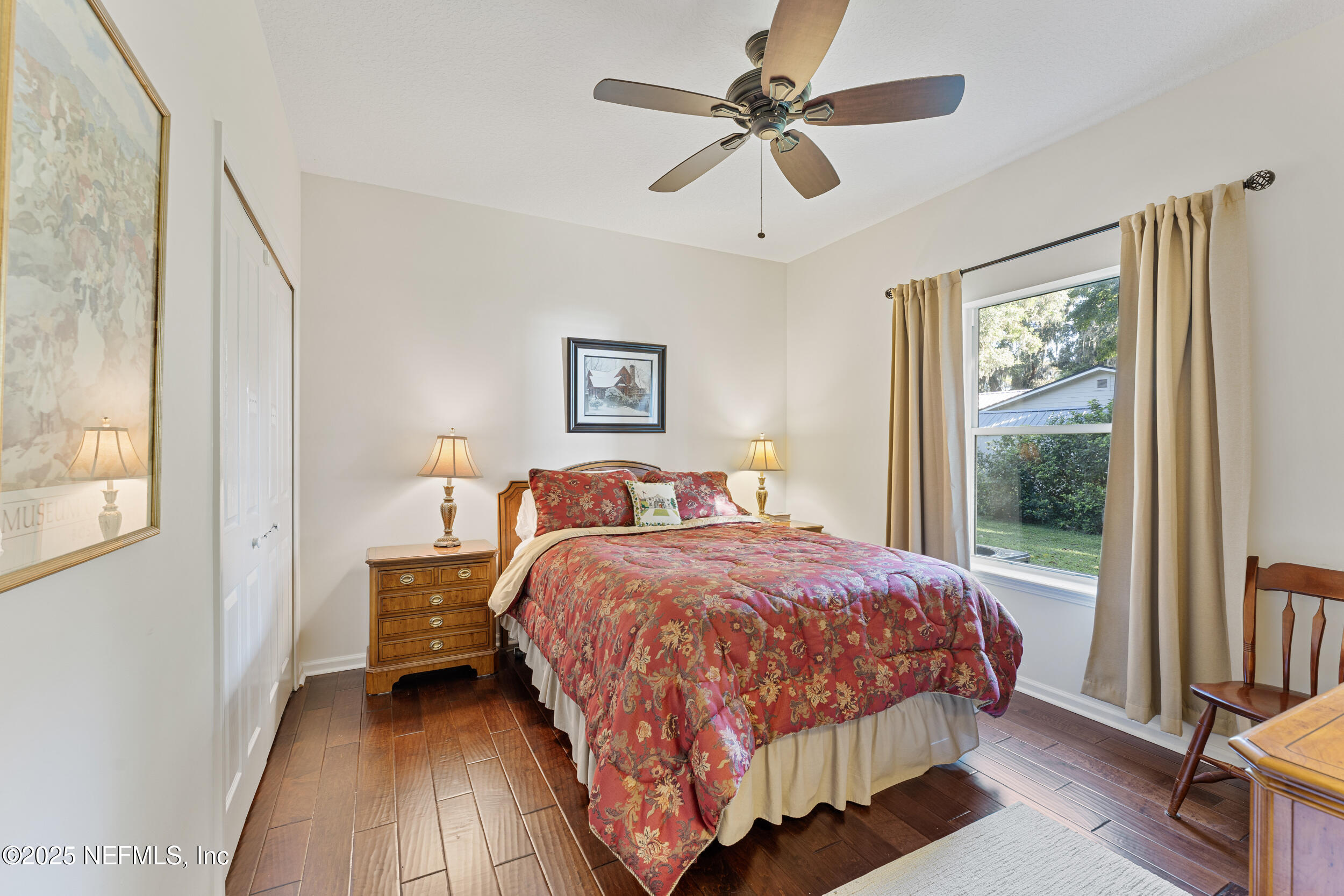 686 Frederic Drive Fleming Island, FL 32003 - Photo 29 of 57 a bedroom with a bed chandelier and a window