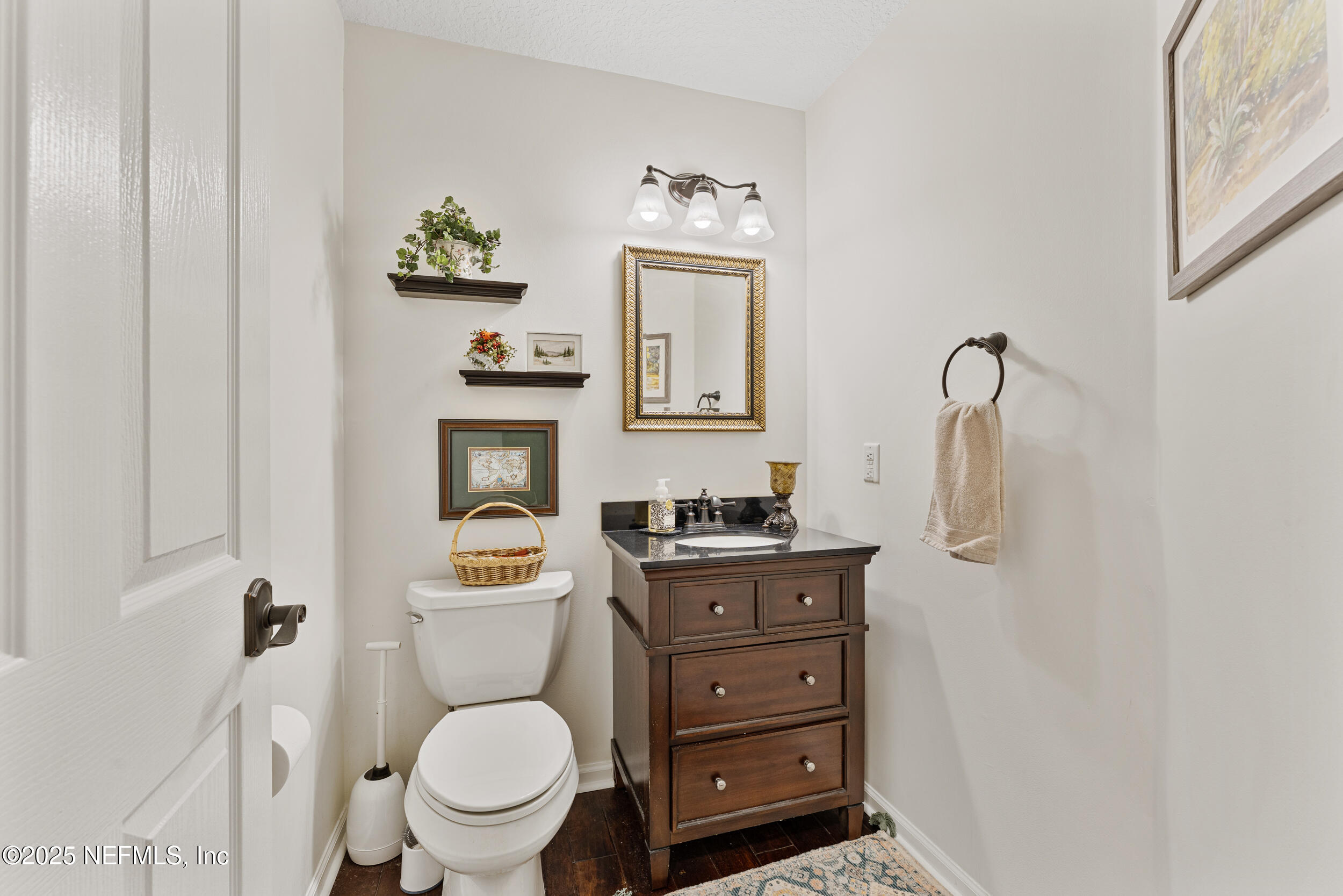 686 Frederic Drive Fleming Island, FL 32003 - Photo 30 of 57 a bathroom with a toilet a sink and mirror