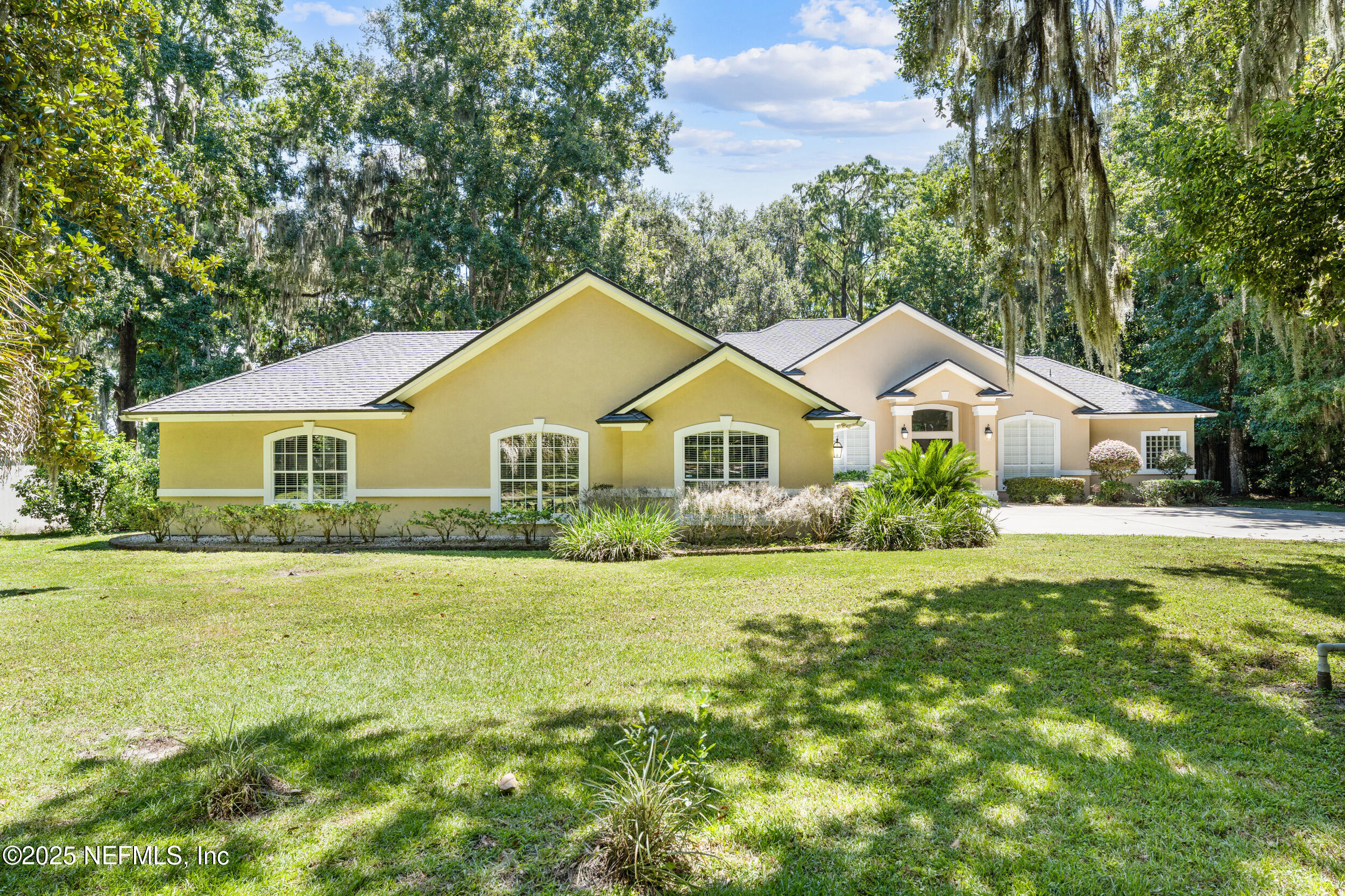 686 Frederic Drive Fleming Island, FL 32003 - Photo 5 of 57 a front view of a house with yard and green space