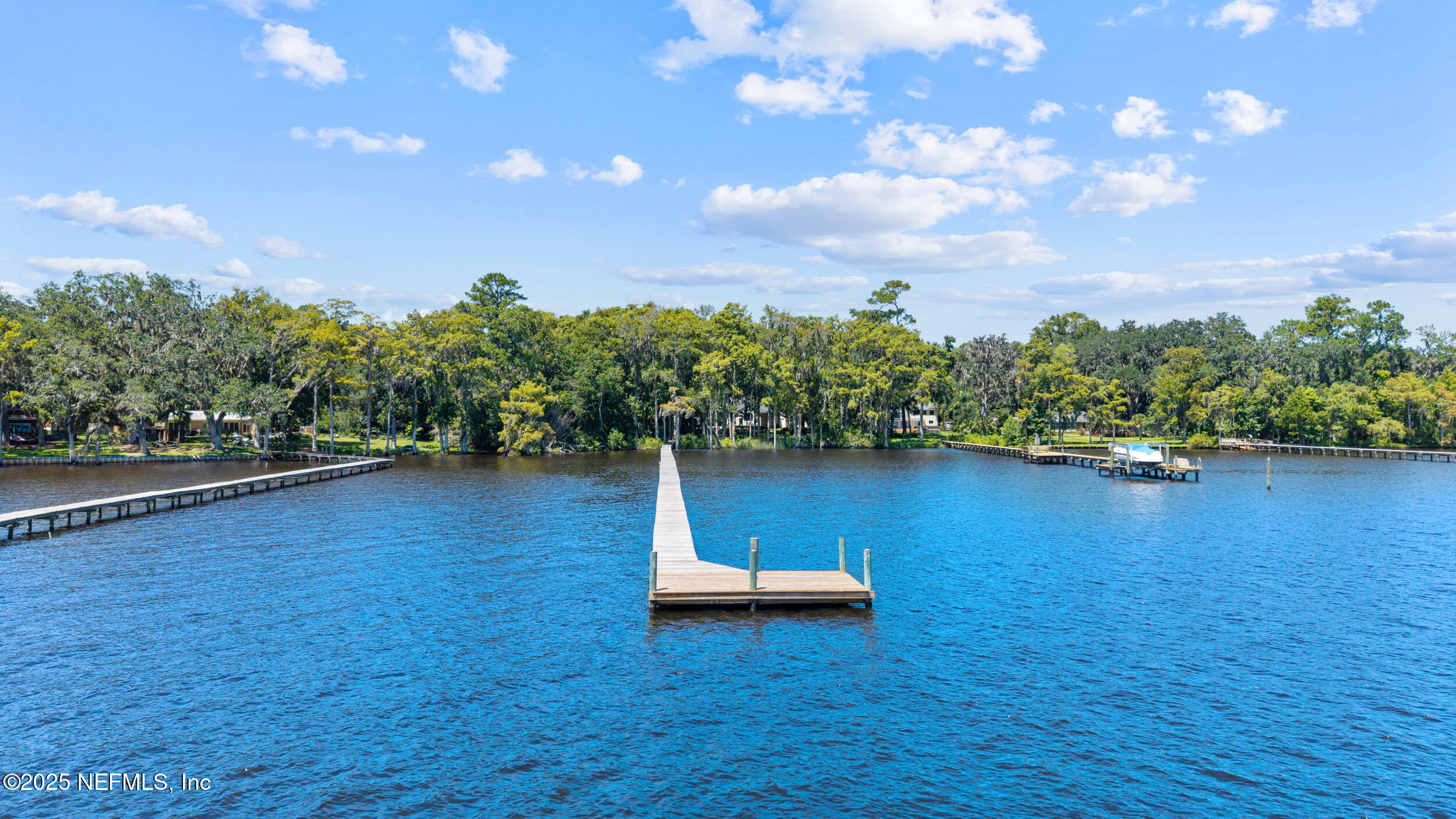 686 Frederic Drive Fleming Island, FL 32003 - Photo 54 of 57 a view of a lake with a yard