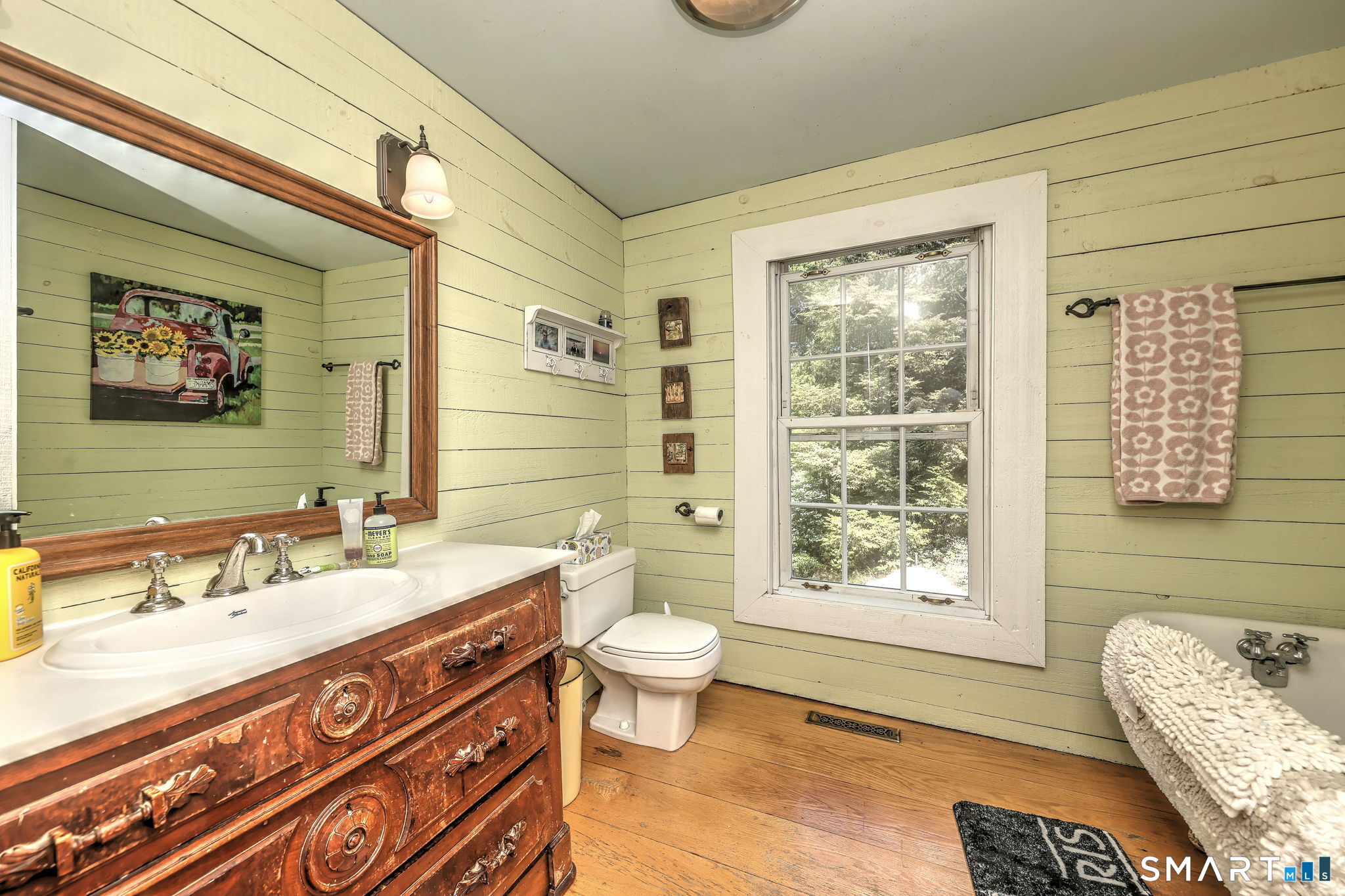 25 Center Road Woodbridge, CT 06525 - Photo 24 of 34 a bathroom with a double vanity sink toilet and a mirror