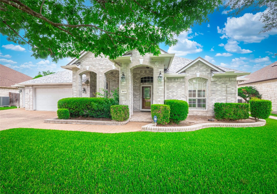 16621 Malaga Hills Drive Round Rock, TX 78681 - Photo 1 of 1 a front view of a house with a yard and potted plants