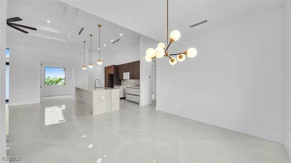 a view of a kitchen with a table and chairs