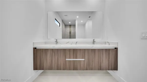 a bathroom with a sink double vanity and a mirror
