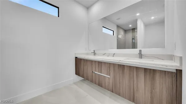 a bathroom with a sink double vanity and a mirror