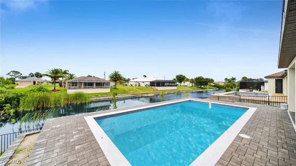 a bathroom with a granite countertop bathtub shower and sink