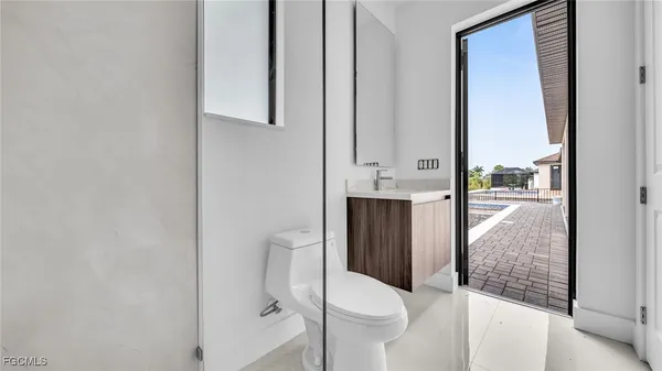 a open kitchen with stainless steel appliances granite countertop a refrigerator and a stove top oven