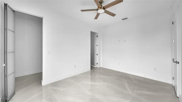 a view of a livingroom with a ceiling fan and window