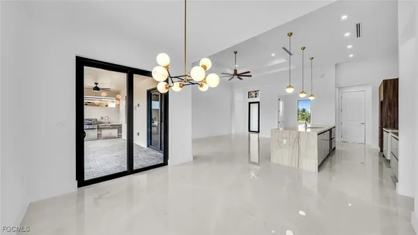 a view of a kitchen with a refrigerator and a chandelier