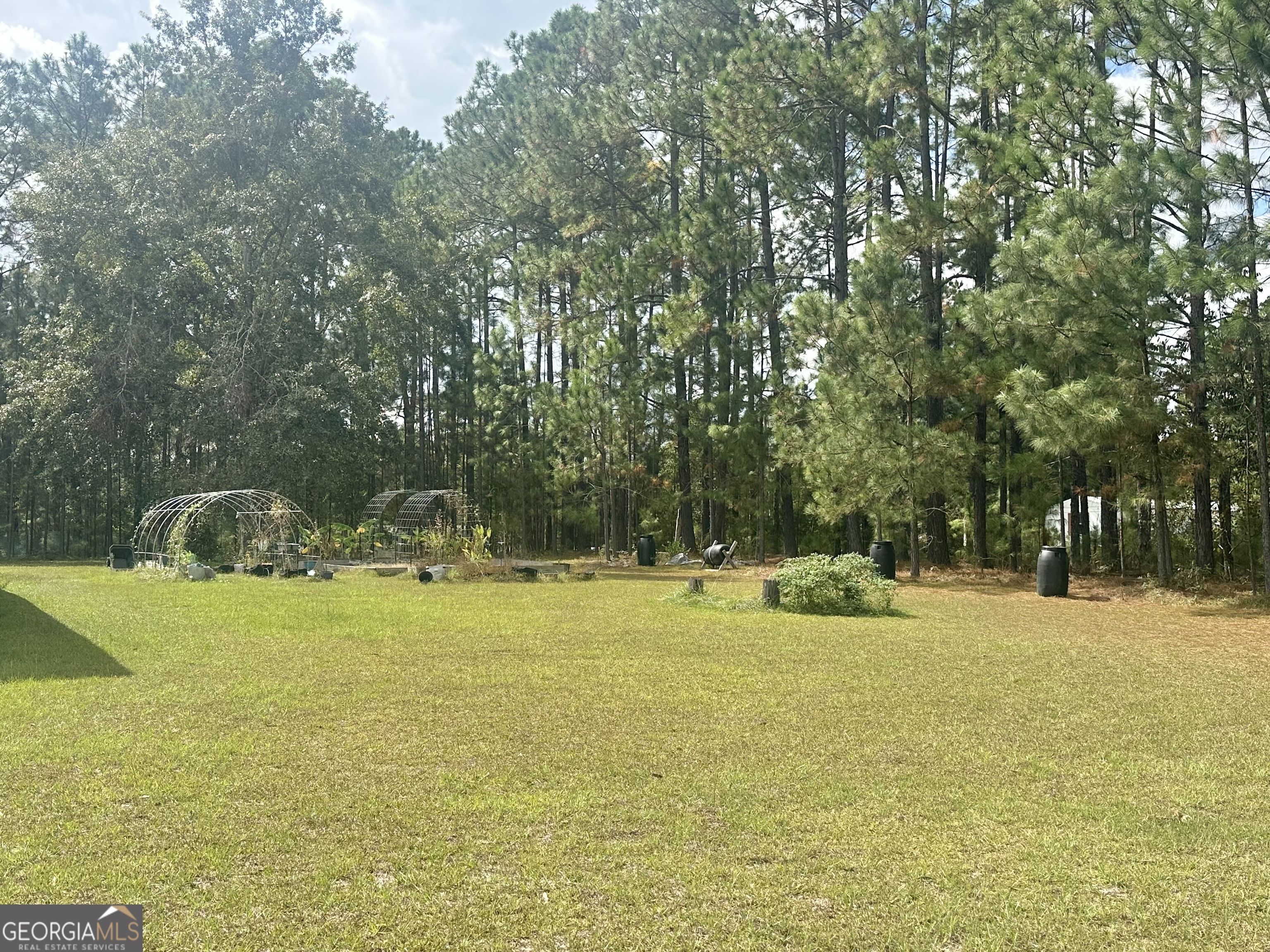251 Bill Hambrick Road Eastman, GA 31023 - Photo 2 of 32 a view of a swimming pool with an outdoor space and seating area