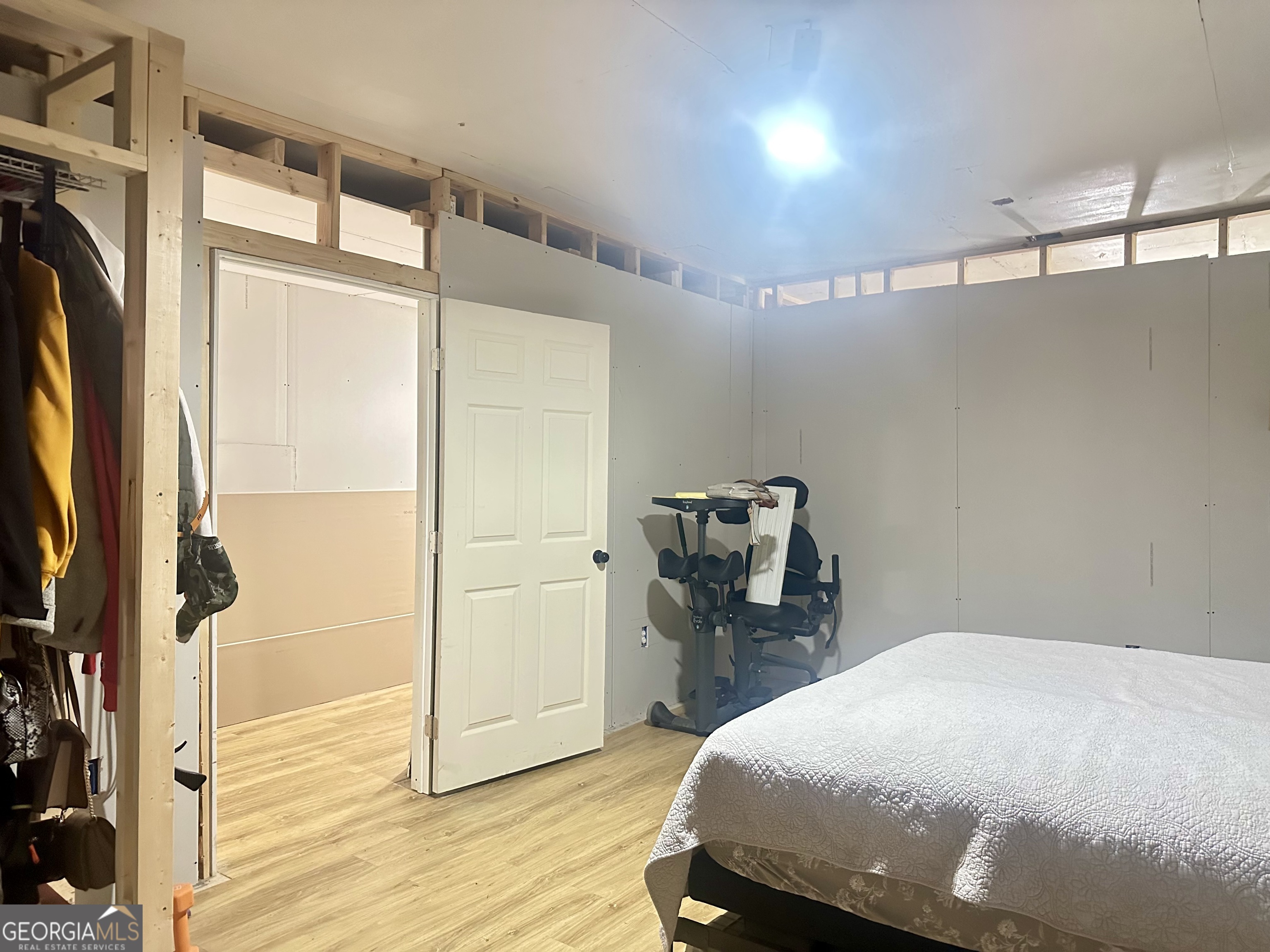 251 Bill Hambrick Road Eastman, GA 31023 - Photo 24 of 32 a bedroom with a bed and wooden floor