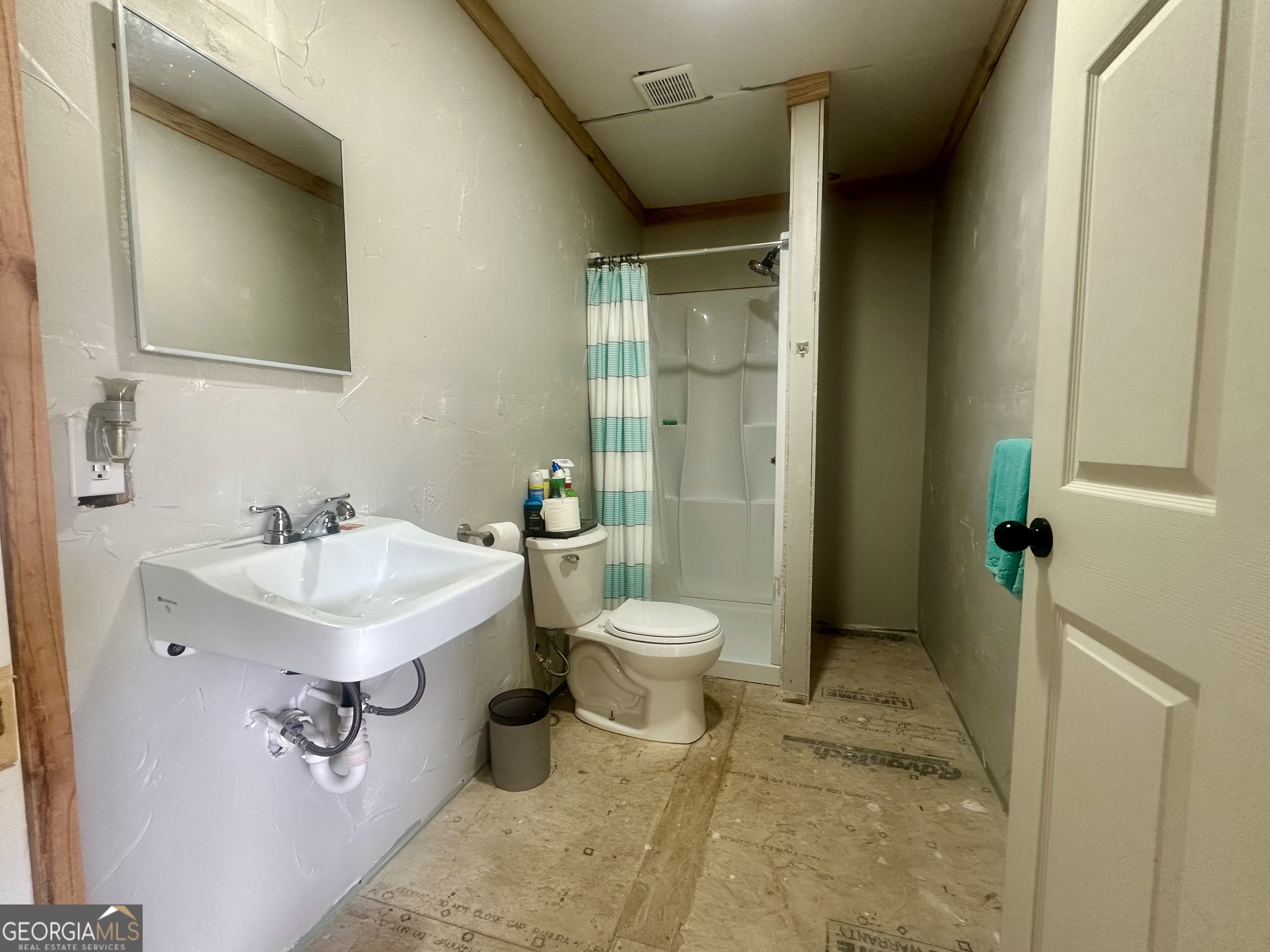 251 Bill Hambrick Road Eastman, GA 31023 - Photo 31 of 32 a bathroom with a sink toilet and shower