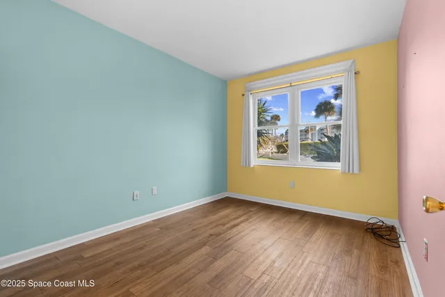a view of a room with wooden floor and wall painting