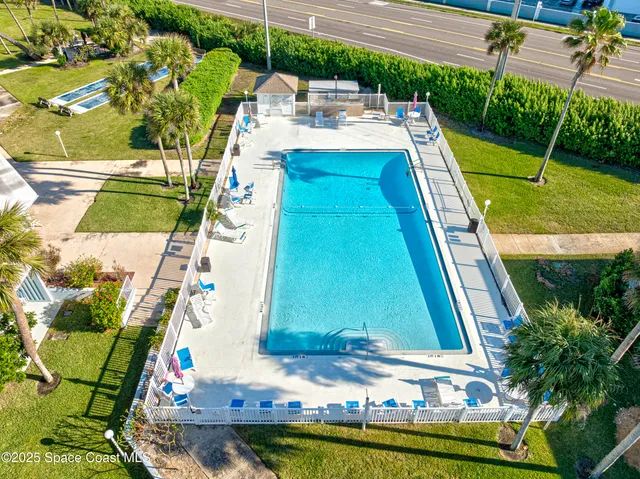 a view of swimming pool with a yard and seating area