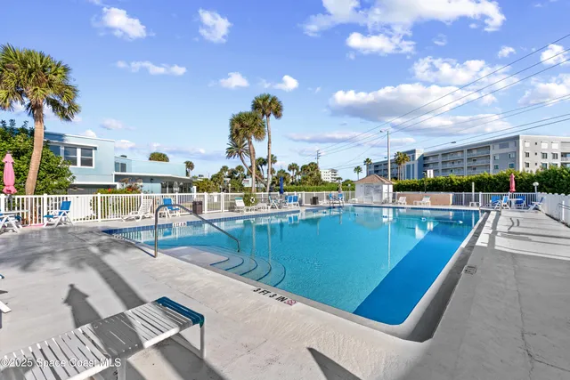 a view of a swimming pool with an outdoor seating