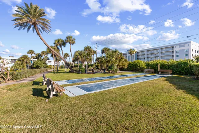 a view of swimming pool with outdoor seating and plants