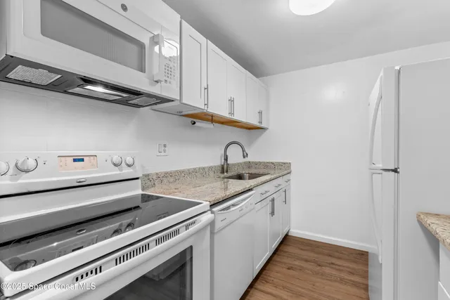 a kitchen with a sink cabinets and appliances