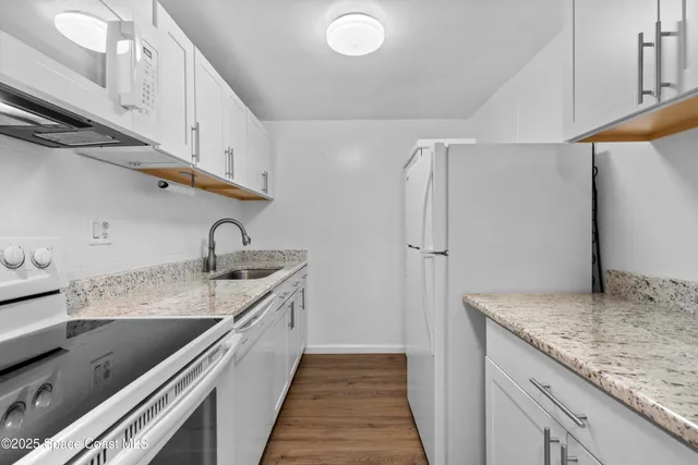 a kitchen with stainless steel appliances granite countertop a sink and cabinets
