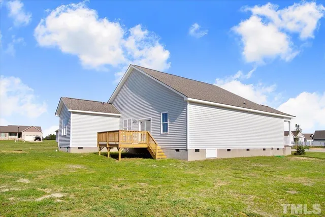 a view of yard with swimming pool and green space